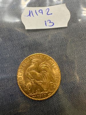 a close up of a gold coin with a label on it