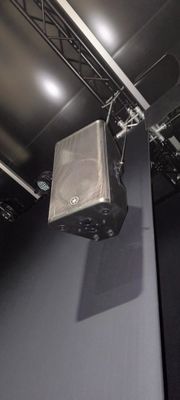 a speaker that is hanging from the ceiling in the room