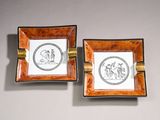 pair of small square ashtrays decorated with images of a man and a woman