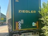 a green truck that is driving down the road