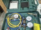a green case with a couple of gauges in it