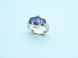 an image of a ring with a blue stone