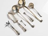five spoons and two spoon spoons on a white surface