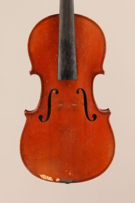 an old violin with a bow hanging from it ' s back