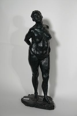 statue of a woman standing on a rock with her hands on her hips