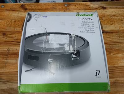 the box of the robot is open on the wooden table