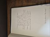 an open book with writing on it sitting on a table