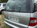 a silver car that is parked in the grass
