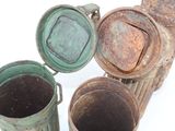 four buckets sitting next to each other on a white surface