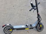 a scooter that is sitting on the ground in the parking lot