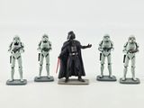 star wars figurines are lined up in a row on a white surface