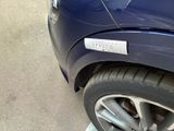 a close up of a car ' s tire with a sticker on it
