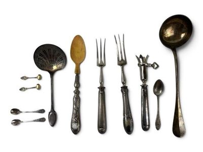many spoons, forks, and spoon spoons laid out on a white surface