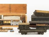 many different types of toy trains and boxes on a white surface