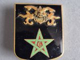 an image of a black and gold badge with a star on it