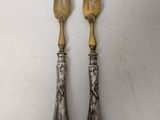 pair of antique silverware forks and spoons on a white background