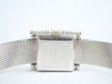an image of a close up of a watch on a white surface