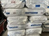 a large stack of bags of cement in a warehouse