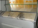 a glass display case in the middle of a kitchen