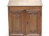 a small wooden cabinet with two doors and a drawer