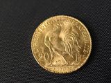 a close up of a gold coin with a rooster on it
