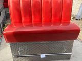 a red bench that is sitting in the back of a firetruck