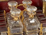bottles of perfume sitting on top of a wooden table next to a piano