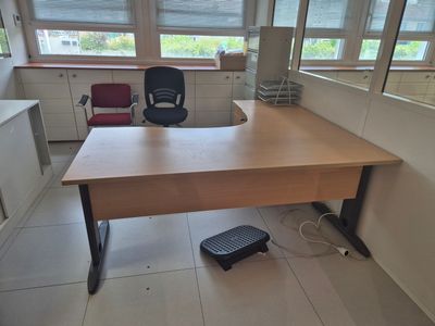 a desk with a chair and a foot stool in an office