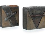 pair of wooden bookends with metal handles on a white surface