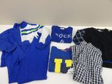 a group of clothing sitting on top of a white table