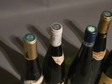 several bottles of wine are lined up on a table