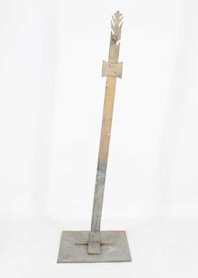 sculpture of a metal arrow on a metal base on a white background