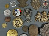 a lot of different types of badges on a table