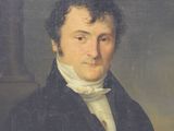 portrait of a man in a black coat and white shirt