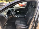the interior of a car with the door open and the driver ' s seat down