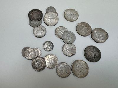 a lot of silver coins on a white surface