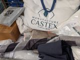 a bag that is sitting on top of a pile of clothing