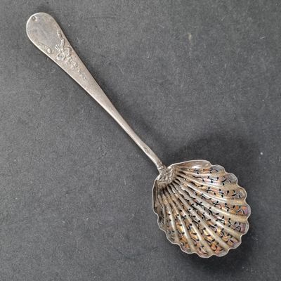 un gros plan d'une cuillère posée sur une table, dans laquelle se trouve une autre cuillère