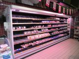 a large display of meat in a grocery store