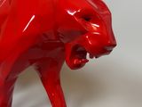 a red bear figurine on a white background