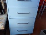 a blue chest of drawers in the corner of a room