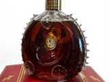 a bottle of liquor sitting on top of a red box