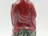 an image of a figurine of a person sitting on a tree stump