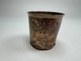 a silver cup with a floral design on it