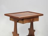 a small wooden table with a drawer on it