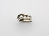 two peas in a pod with pearls on a white surface