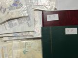 a lot of papers and a binder on a table