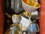 a red box filled with different types of vases and bowls