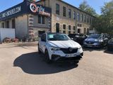 a white car parked in front of a building