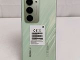 the back of a green samsung note 20 lite with a sticker on it
